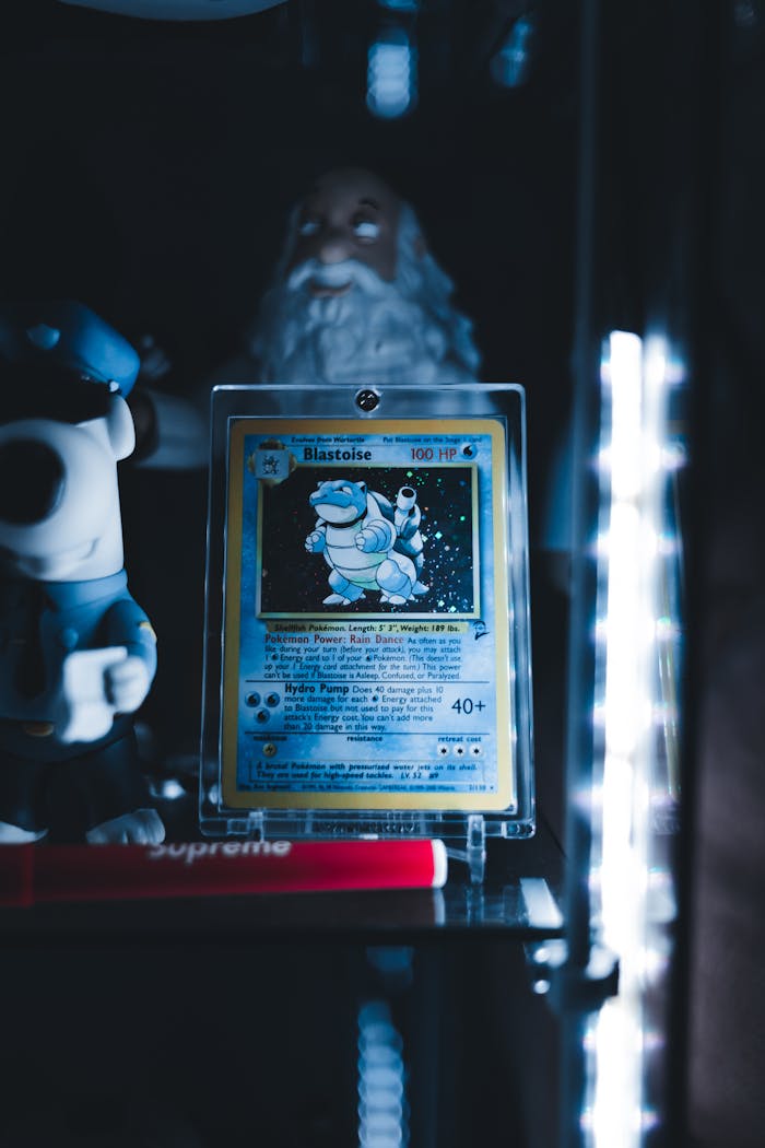 Mastering the First Impression: Your intriguing post title goes here Blastoise Pokémon card in a protective case on display shelf with collectibles and ambient lighting.